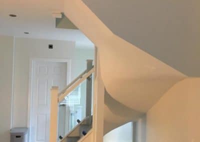 White spiraled stairway to loft conversion