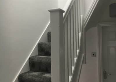 White stairwell to loft conversion with dark grey carpets