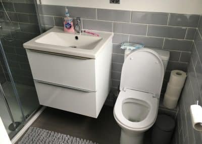 Fitted bathroom - grey tiles with sink and toilet