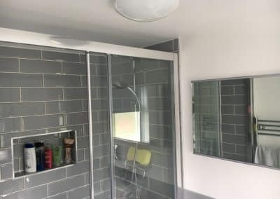 Bathroom extension with grey tiled walk in shower