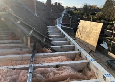 Loft conversion extending roof structure