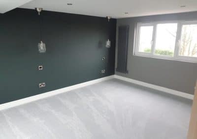Loft conversion - empty room with green wall