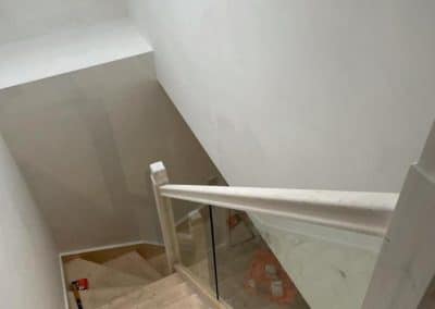 Downwards view of stairs being built up to loft conversion - white walls
