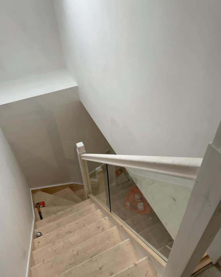 Downwards view of stairs being built up to loft conversion - white walls